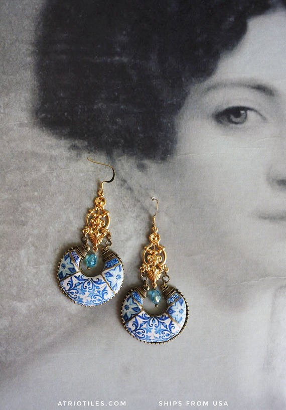 Gold earrings with round azulejo blue tile replica on the bottom.