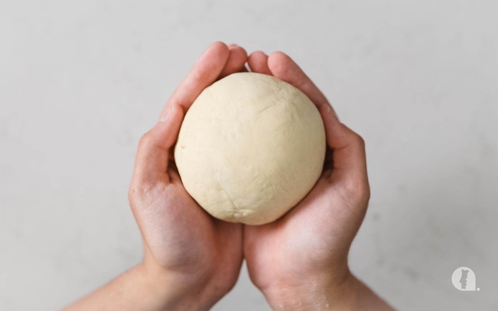 Smooth dough held in both hands.