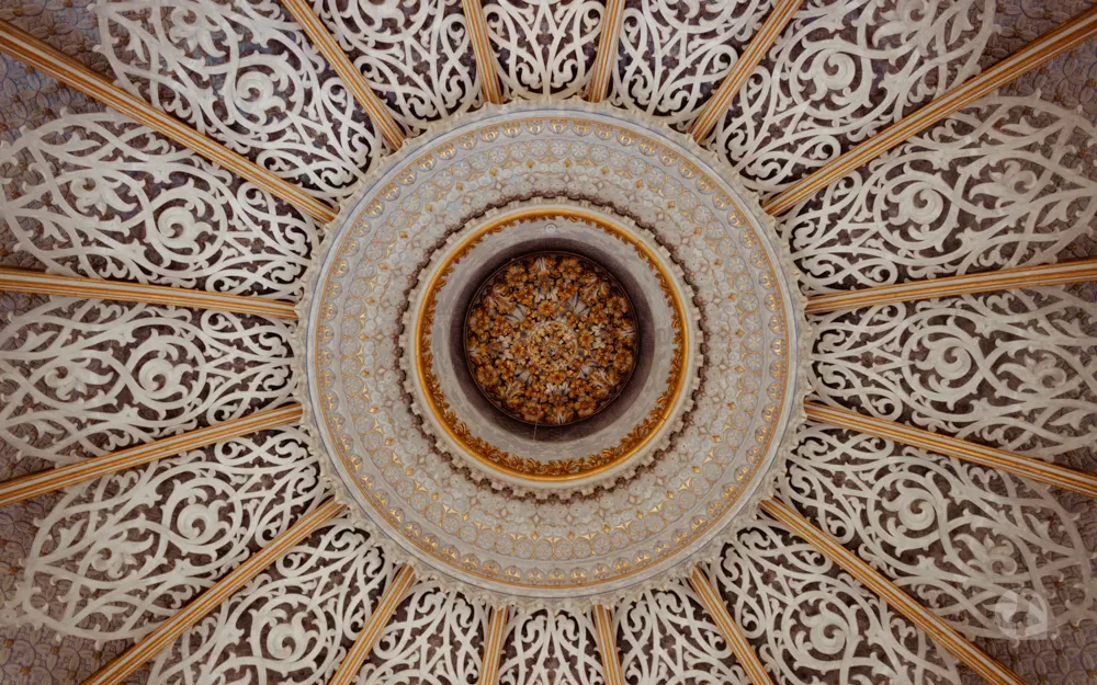 Ceiling designed with carvings and other embellishments.